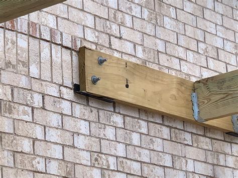 metal l brackets as a ledger|ledger board to brick wall.